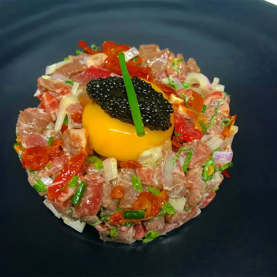 Wagyu filet tartare topped with egg yolk and caviar